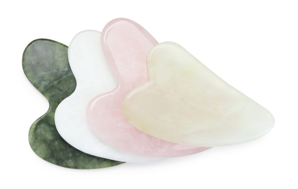 Different Gua Sha Tools Isolated On White, Top View